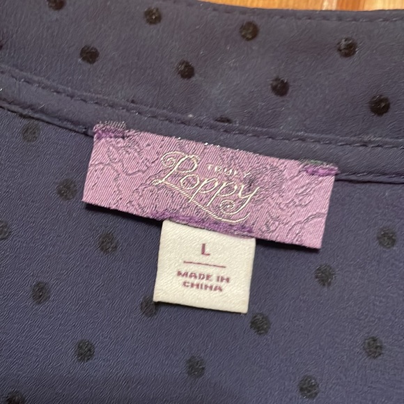 Subtle polka dots and lace cap sleeves make this navy blouse a must-have - Picture 2 of 4